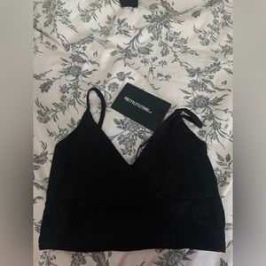 Never worn. Prettylittlething crossover black tank top. Size 8. Great quality.